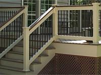 <b>Tan Lincoln Vinyl railing with cocktail rail and bronze aluminum balusters</b>